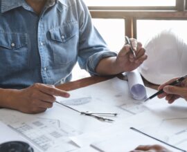 Architects,Interior,Designer,Hands,Working,With,Blue,Prints,And,Documents